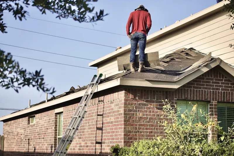 Professional roofer working on a residential roof in Sleepy Hollow Estates